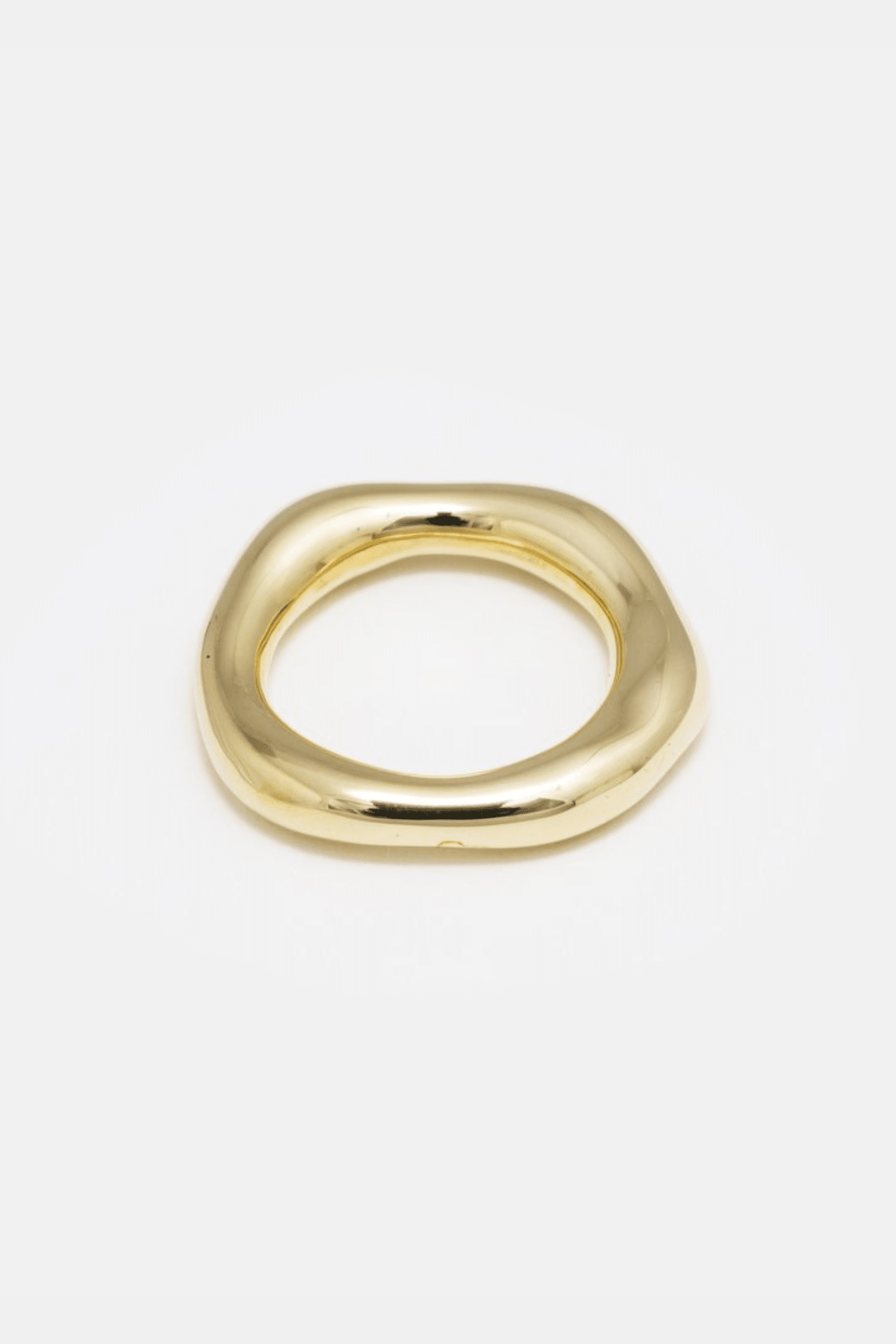 A simple gold brass organic band ring on a white background.