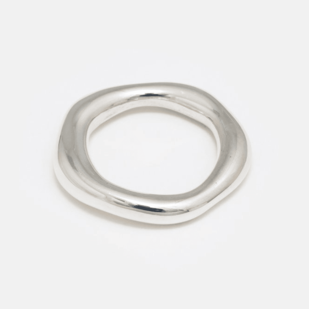 A simple, organic-shaped silver ring, with a matte finish, against a white background.