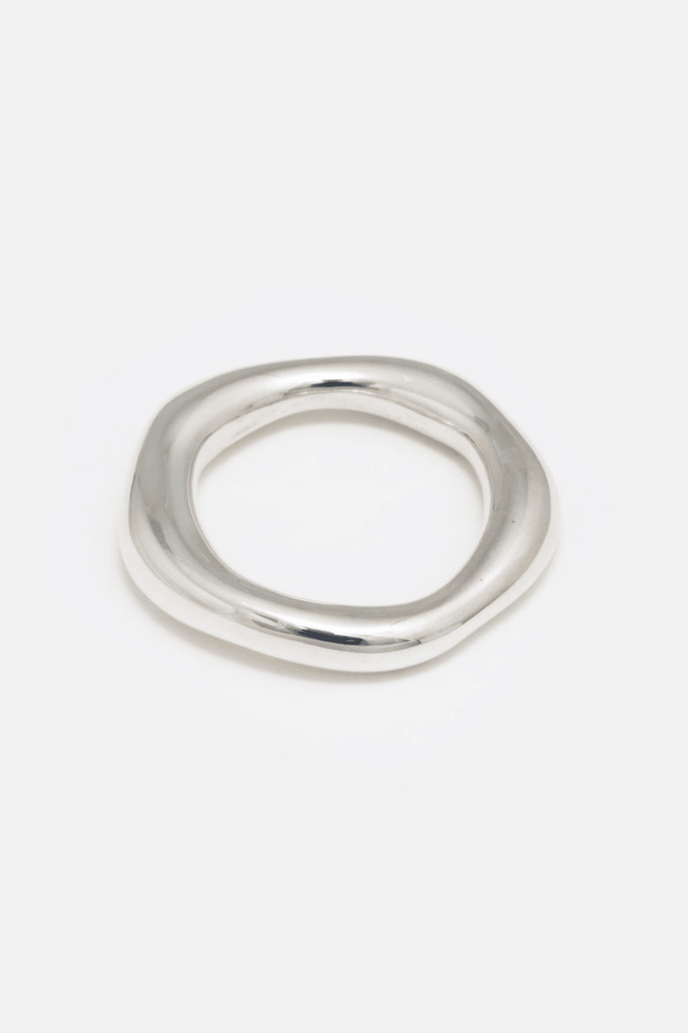 A simple, organic-shaped silver ring, with a matte finish, against a white background.