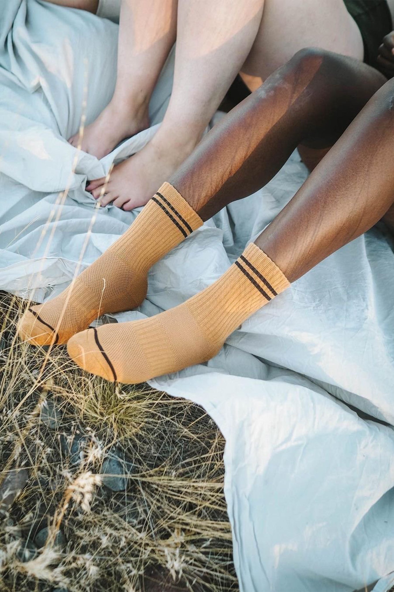 A person wearing yellow ribbed striped crew socks