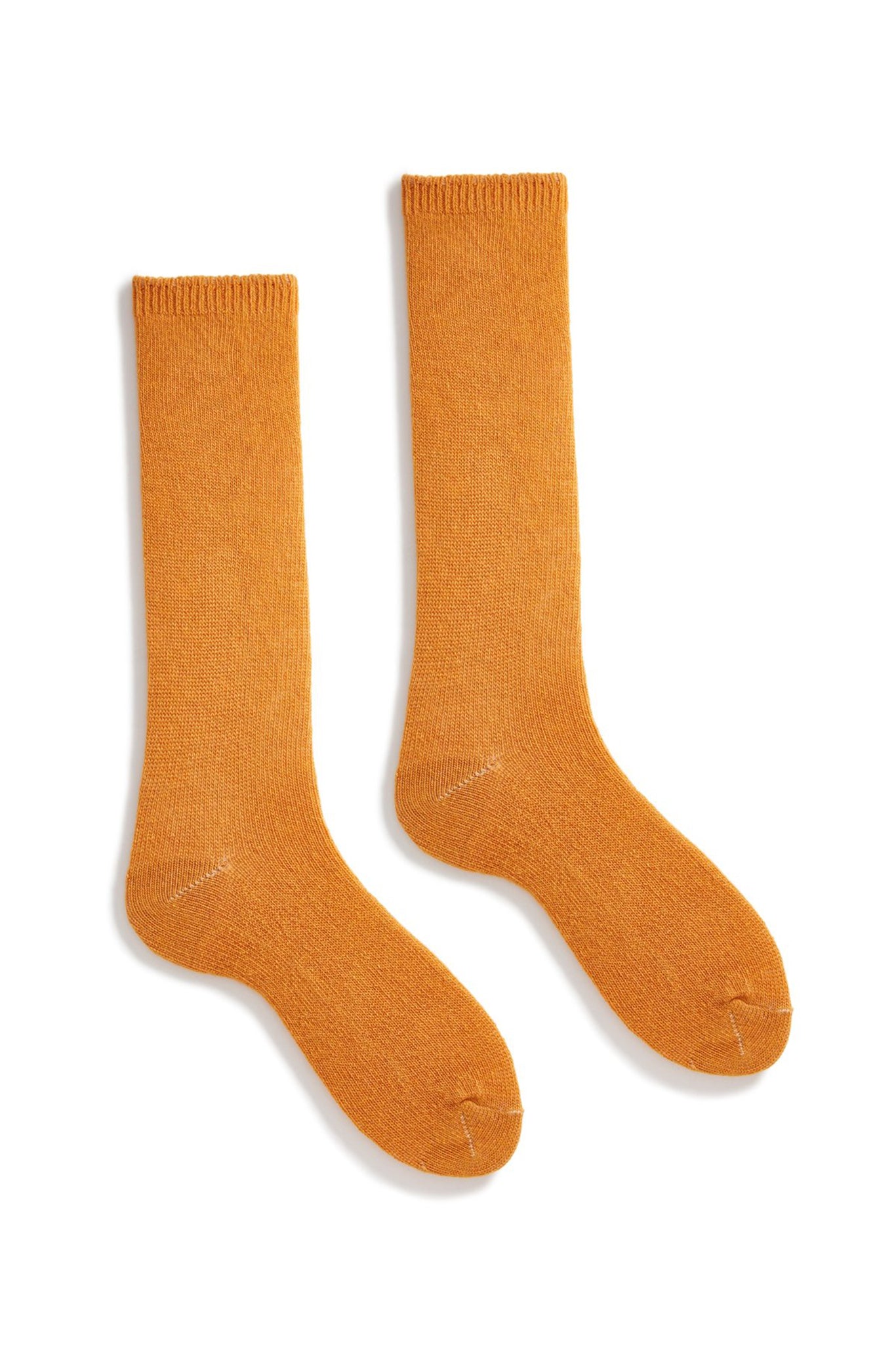 A pair of squash orange wool cashmere socks laid out flat.