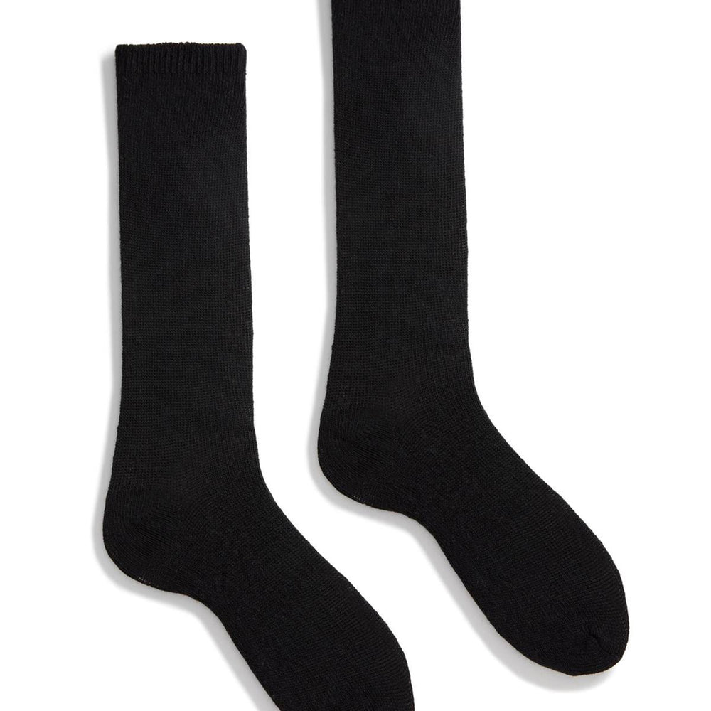 A pair of black cashmere socks against a white background.