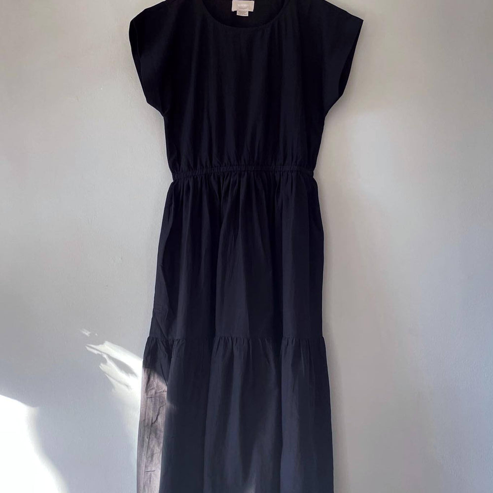 
                  
                    A hanger shot of a black tiered maxi dress
                  
                